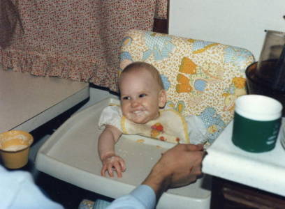 Baby Rebekah with formula all over her face