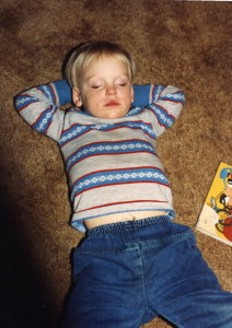 Young John with dirty face napping after a long birthday bash