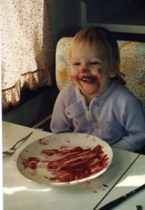 Toddler Rebekah with purple food (of some sort) all over her face--except the circle surrounding her mouth where she licked it off