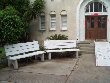 white benches outside building