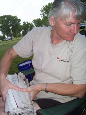 Mom rolling newspaper into firewood logs