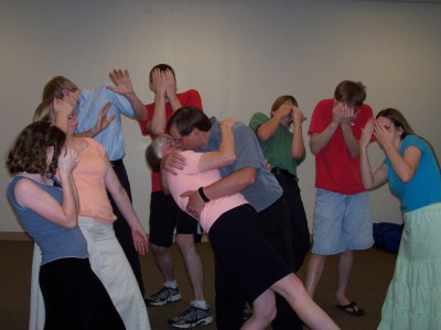 Mom and Dad kissing while the kids look away in horror