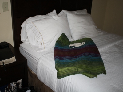 Personal belongings on hotel bed