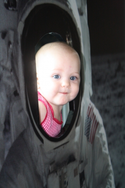 A bright-eyed Tirzah Mae looks out from her space suit