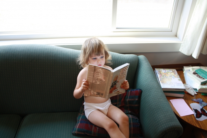 Tirzah Mae reading "Keys to Toilet Training"