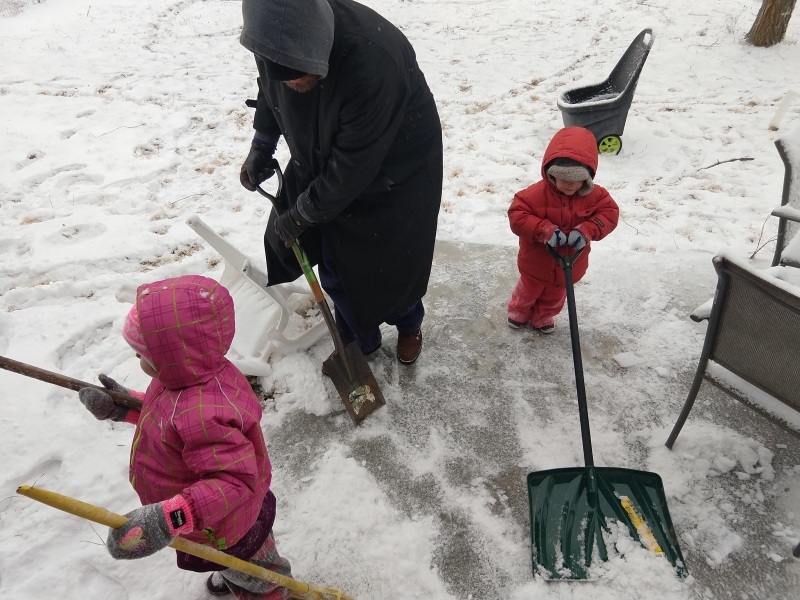 Helping papa shovel the patio